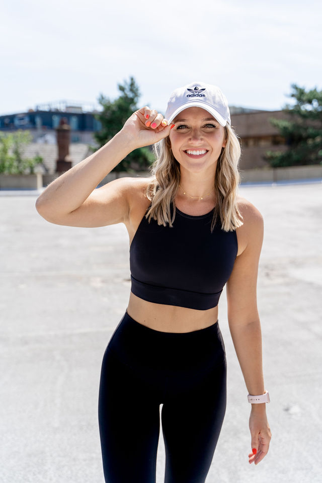 fitness model posing with hat